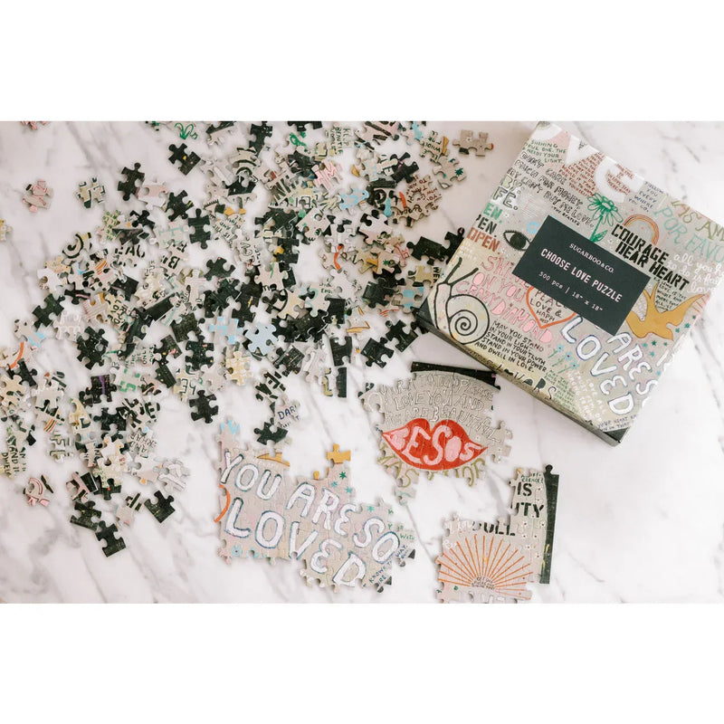 Scattered puzzle pieces and box of Choose Love Puzzle 500PCS for shop Daisy