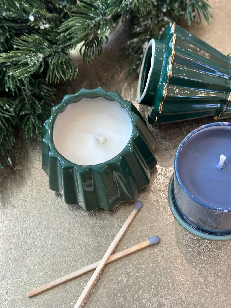 Scented ceramic candle in green and blue containers with pine branches for shop daisy