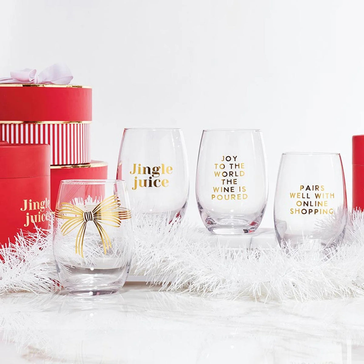 Set of festive stemless wine glasses with holiday gold lettering for entertaining