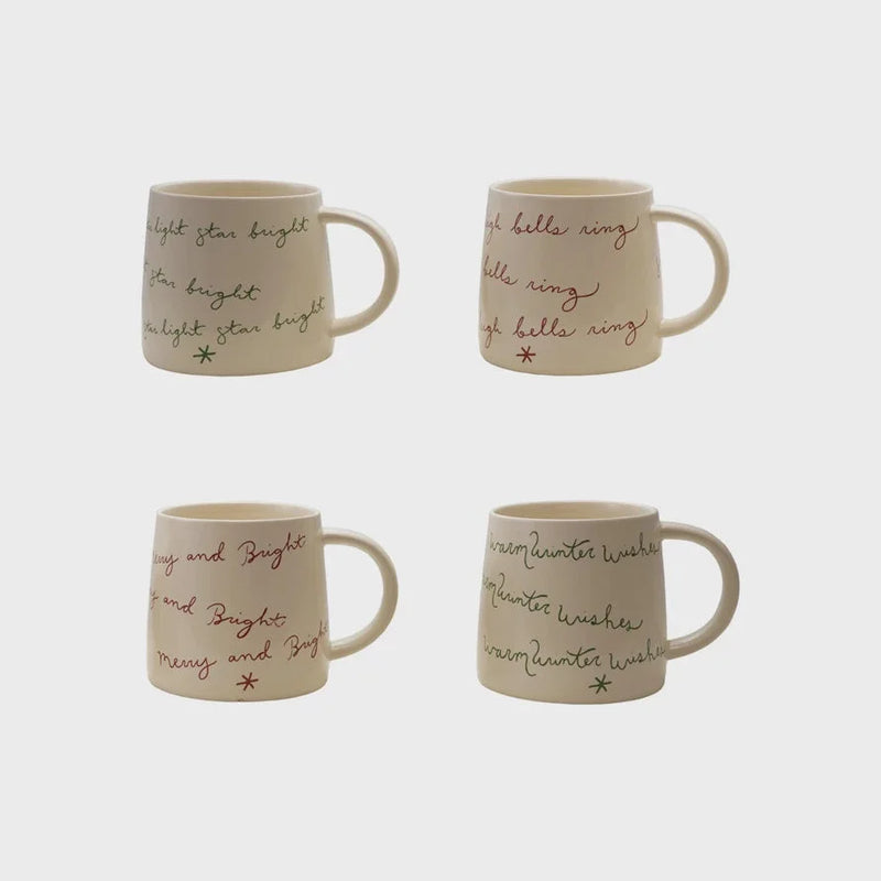 Cream color ceramic mugs with holiday sayings and star design, perfect for shop Daisy