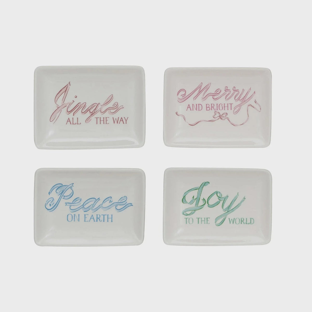 Set of four white stoneware dishes with holiday phrases in pastel lettering