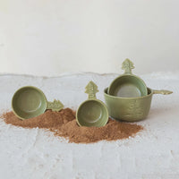 Set of green stoneware tree measuring cups shaped like playful trees