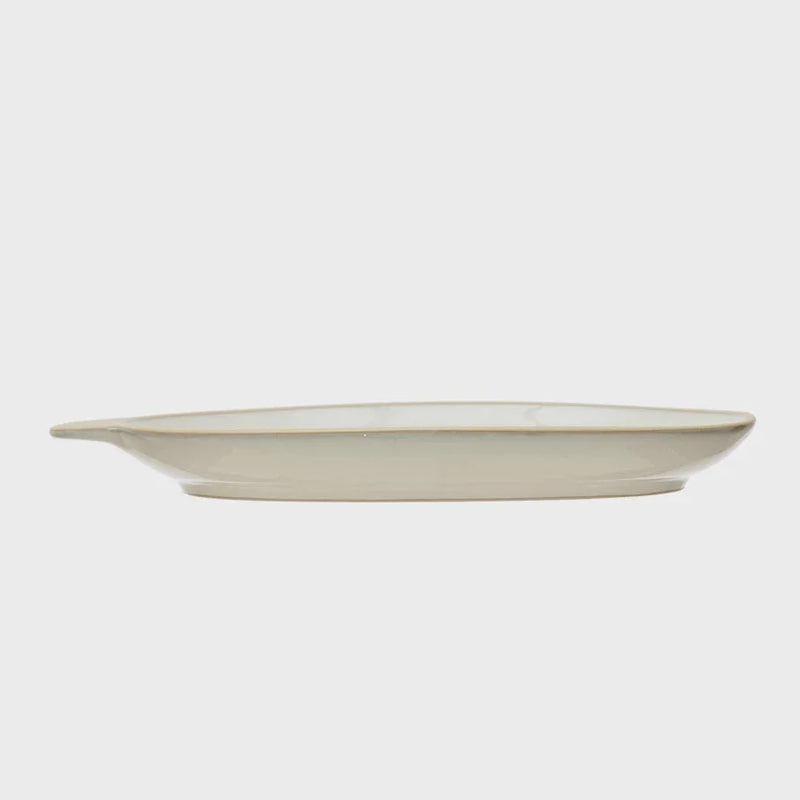 Shallow off-white ceramic plate with raised rim for a boho-inspired table setting