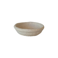 Shallow round stone bowl with smooth pale surface, perfect for handmade paper mache decor