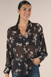 Sheer long sleeve button-down floral top with black fabric and white floral print