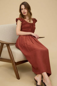Rust-colored midi dress with shirred bodice and ruffled cap sleeves for elegant style