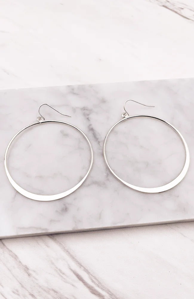 Elegant silver hoop style earrings displayed in a stylish product presentation