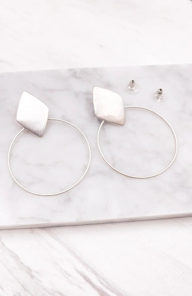 Silver Multi Shape Hoop Earrings elegantly displayed, showcasing unique designs and versatility