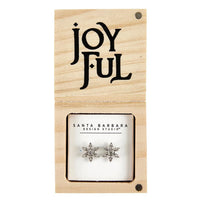 Silver snowflake shaped earrings elegantly displayed on a Joyful wooden card
