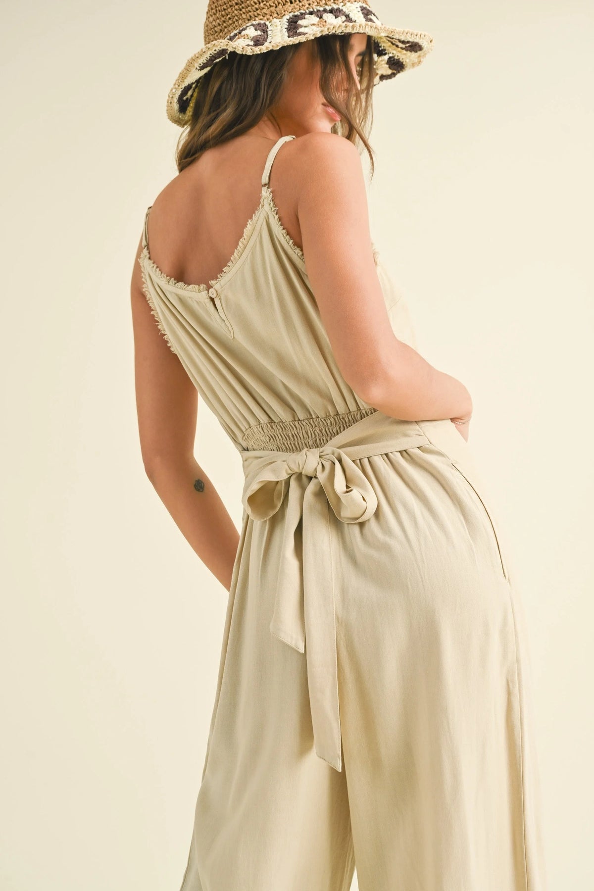 Sleeveless beige DYE & WASH JUMPSUIT with tied waist, perfect for boho summer styles