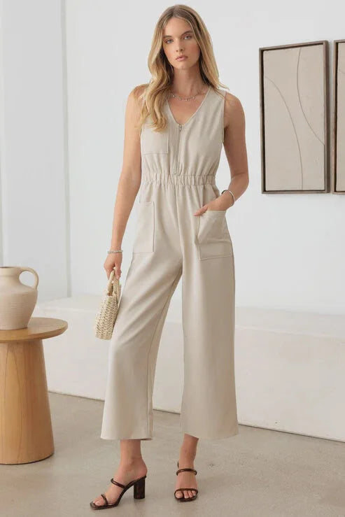 Sleeveless beige jumpsuit with V-neck and wide leg cropped pants for a boho look