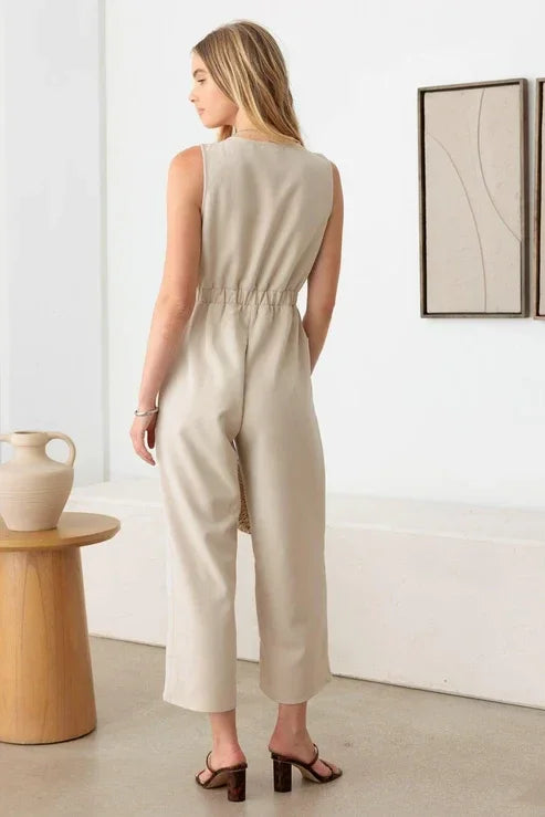 Sleeveless beige jumpsuit with gathered waist and wide-leg pants for a boho flowy look