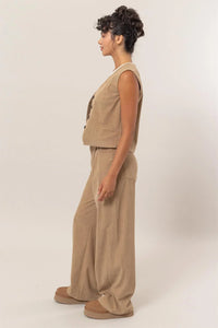 Sleeveless beige linen jumpsuit with wide-leg pants from Shop Daisy, ideal for women’s boho chic clothing