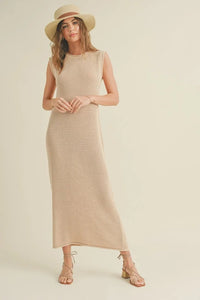 Sleeveless crochet knitted dress with beige maxi style, paired with straw hat and sandals