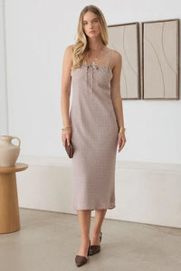 Sleeveless beige polka dot midi dress with thin straps and a straight silhouette