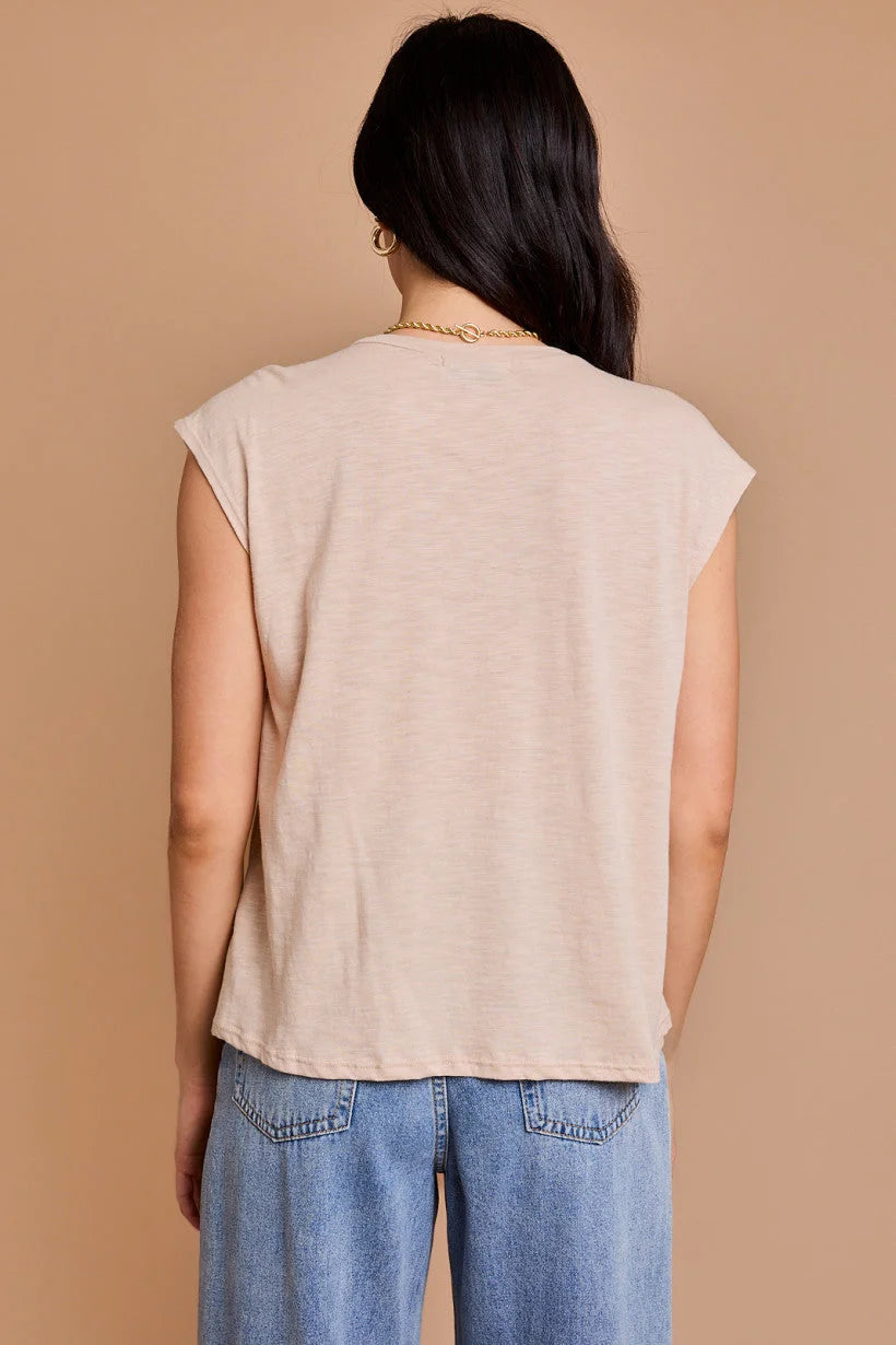 Sleeveless beige top with pleated shoulder detail, showcasing a flowy boho style