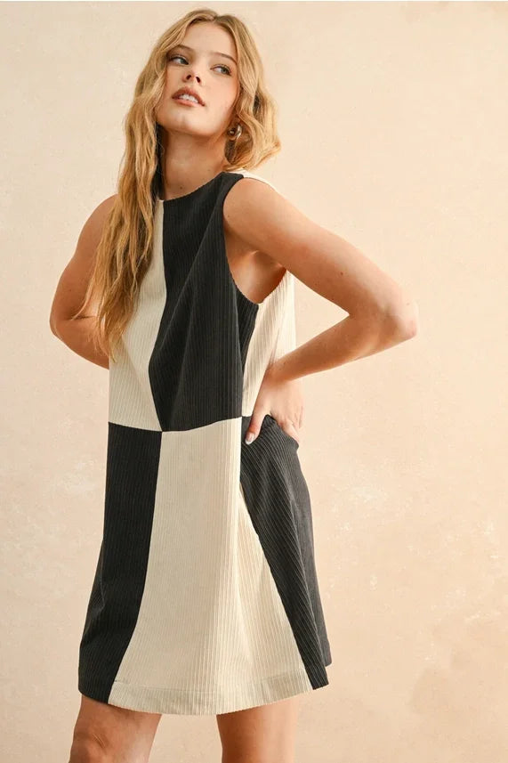 Black and cream corduroy color block mini dress displayed in a stylish mini dress collection