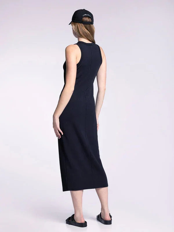 Sleeveless black muscle tank fitted midi dress styled with a baseball cap and sandals