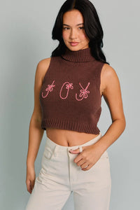 Sleeveless brown crop top sweater featuring pink embroidered text for the Turtle Neck Sleeveless style