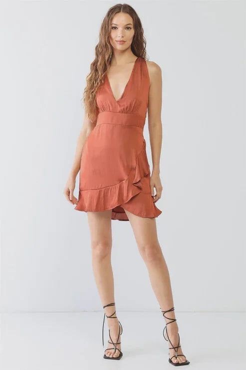 Sleeveless coral mini dress with plunging neckline and ruffled hem for a boho look