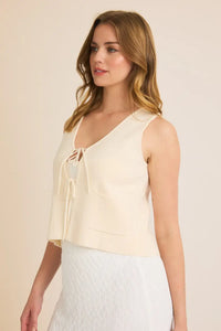 Sleeveless cream-colored tie sweater vest, ideal for stylish layering and comfort