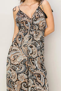 Sleeveless paisley print jumpsuit featuring an intricate muted color pattern