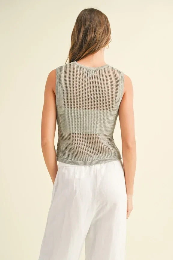 Model showcasing a crochet knitted sleeveless top with a stylish mesh texture