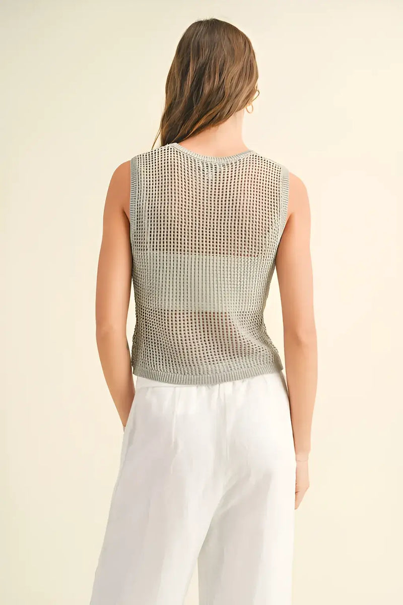 Model showcasing a crochet knitted sleeveless top with a stylish mesh texture