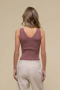 Sleeveless mauve top with scallop edge worn by model, showcasing stylish crop design