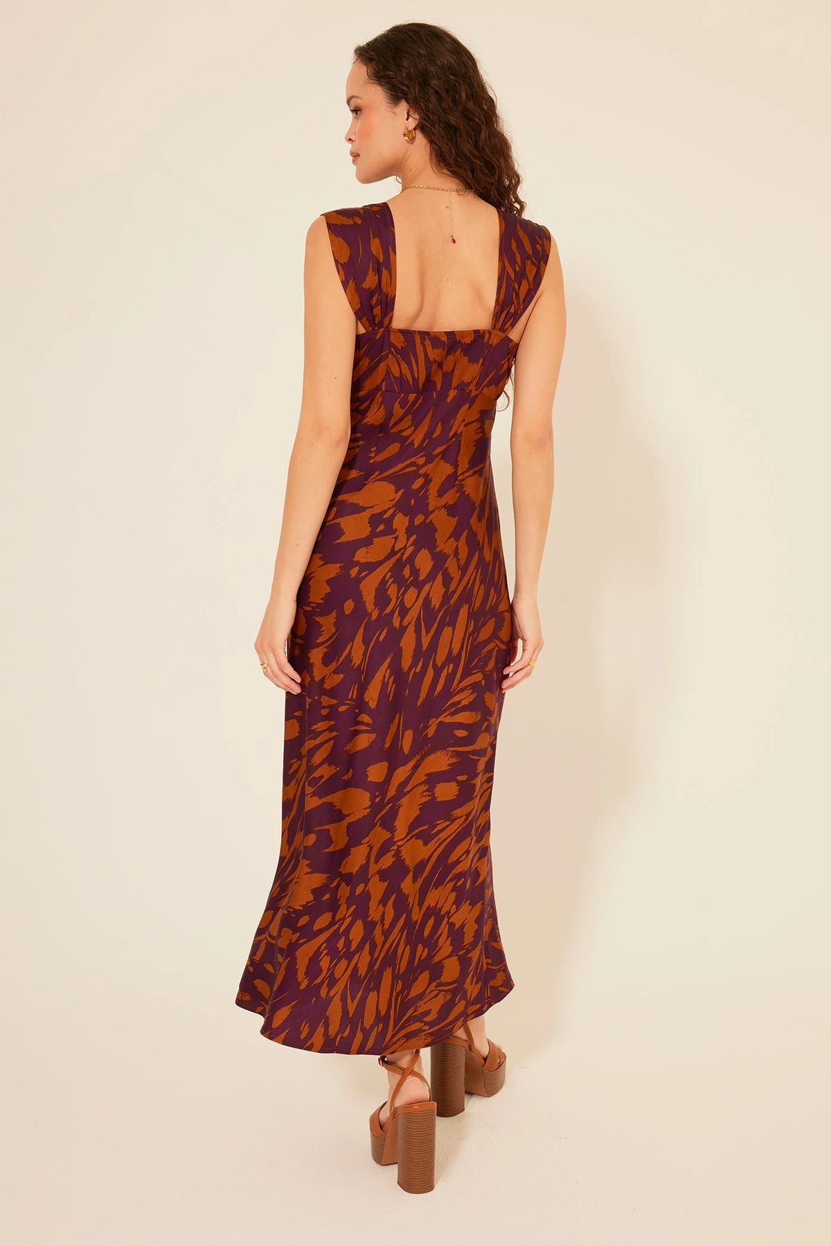 Sleeveless Lucile Maxi Dress featuring a vibrant orange and purple leaf print pattern