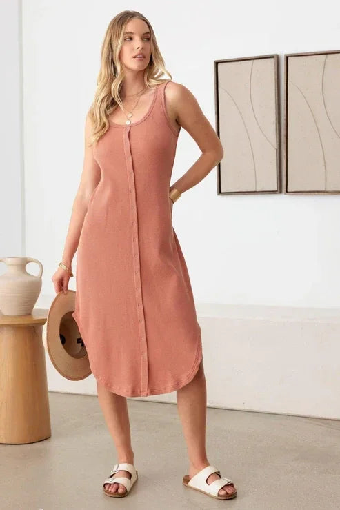 Sleeveless peach midi dress with curved hemline, perfect for a boho free spirit look