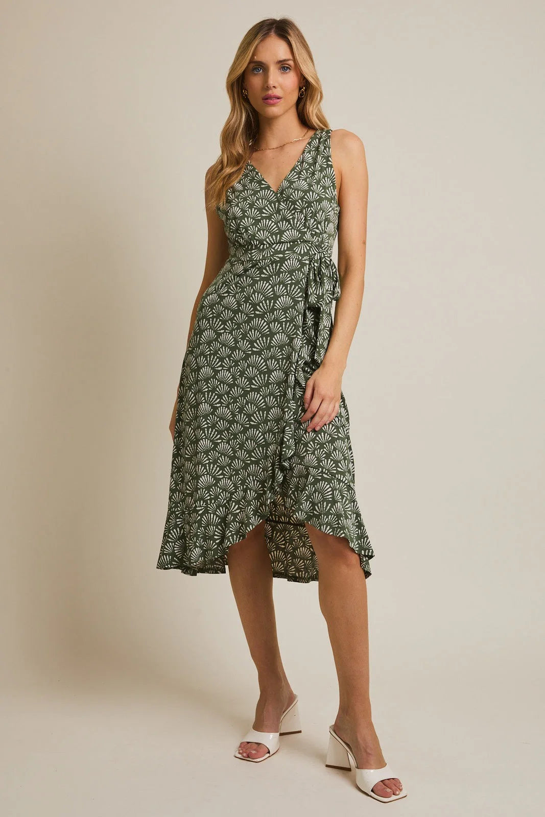 Olive green sleeveless midi dress with V-neck, waist tie, and ruffled high-low hem