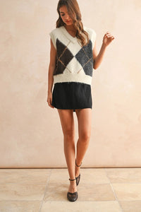 Cream, dark gray, and black argyle pattern sweater vest with V-neck design