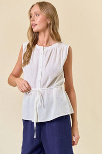 Sleeveless white button-down top with tie, perfect for women’s boho chic clothing at Shop Daisy
