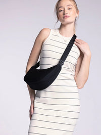 Sleeveless white muscle tank fitted midi dress with black stripes, woman holding black bag