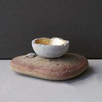 Small egg on rock in Decorative Cement Bowl with gold encrusted design