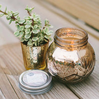 Small jar with a Soy-Blend Sweet Grace Candle and decorative plants. Best-selling fragrance