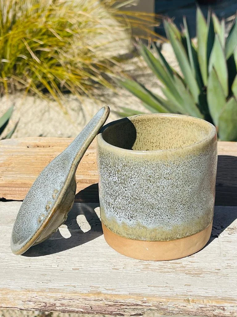 Small pot with lid on wooden table near TEA MUG, CUP & SAUCER set for tea lovers