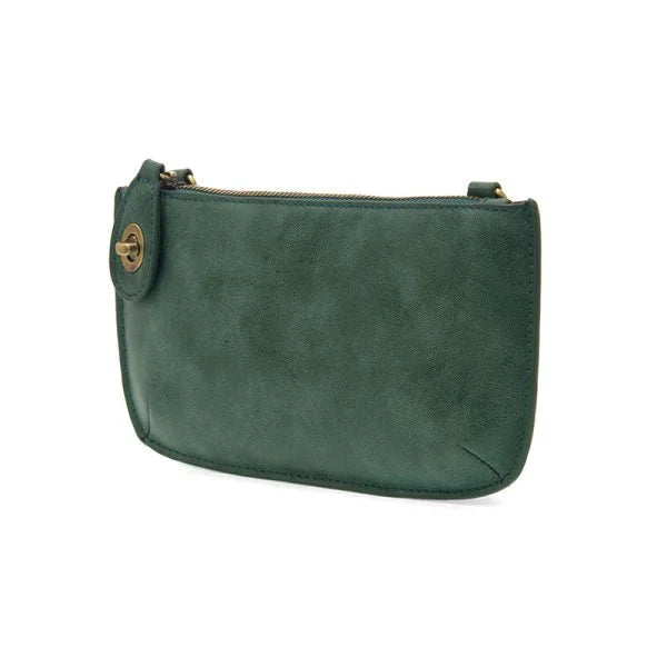 Green suede small pouch of the Lux Crossbody Wristlet Clutch displayed elegantly