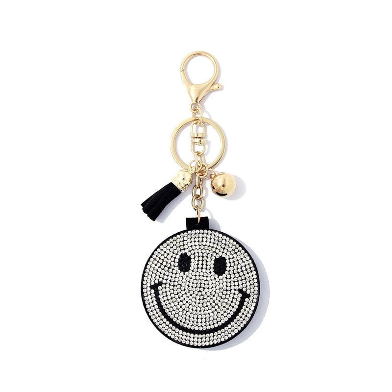 Smiley face key chain with mirror featuring a black and white diamond smiley face design