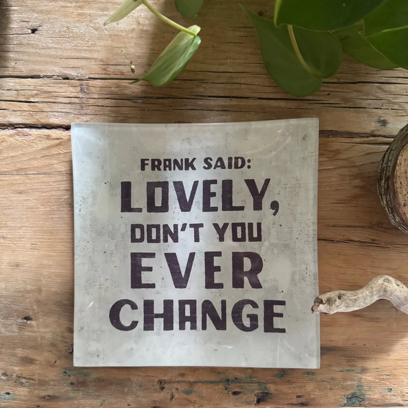Light-colored small square decoupage plate with dark lettering for decorative use