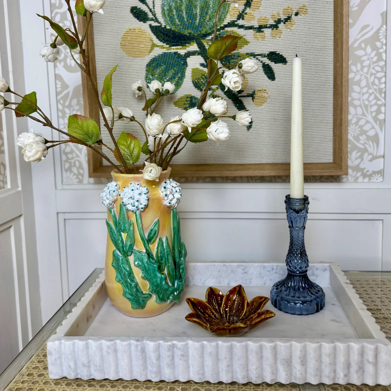 Yellow ceramic stoneware flower shaped dish with white and green floral relief artwork