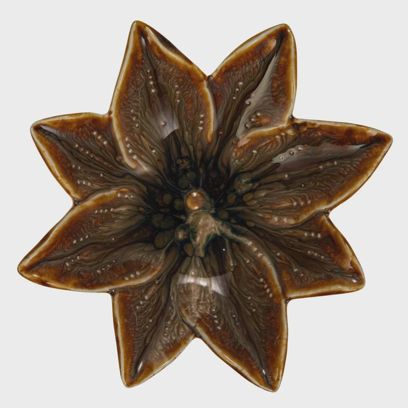 Brown glossy stoneware flower shaped dish with eight-pointed star design for decorative use