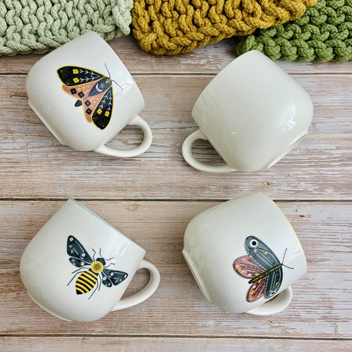 Stoneware mug with vibrant colored rim and insect illustrations, set of four white ceramic mugs