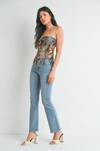 Strapless floral corset top with petite bootcut denim jeans and white heeled sandals