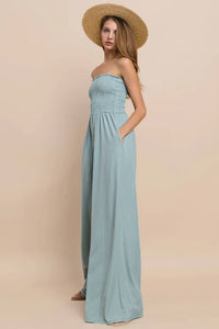 Strapless light blue ribbed knit smocked tube jumpsuit with fitted bodice and flowing skirt