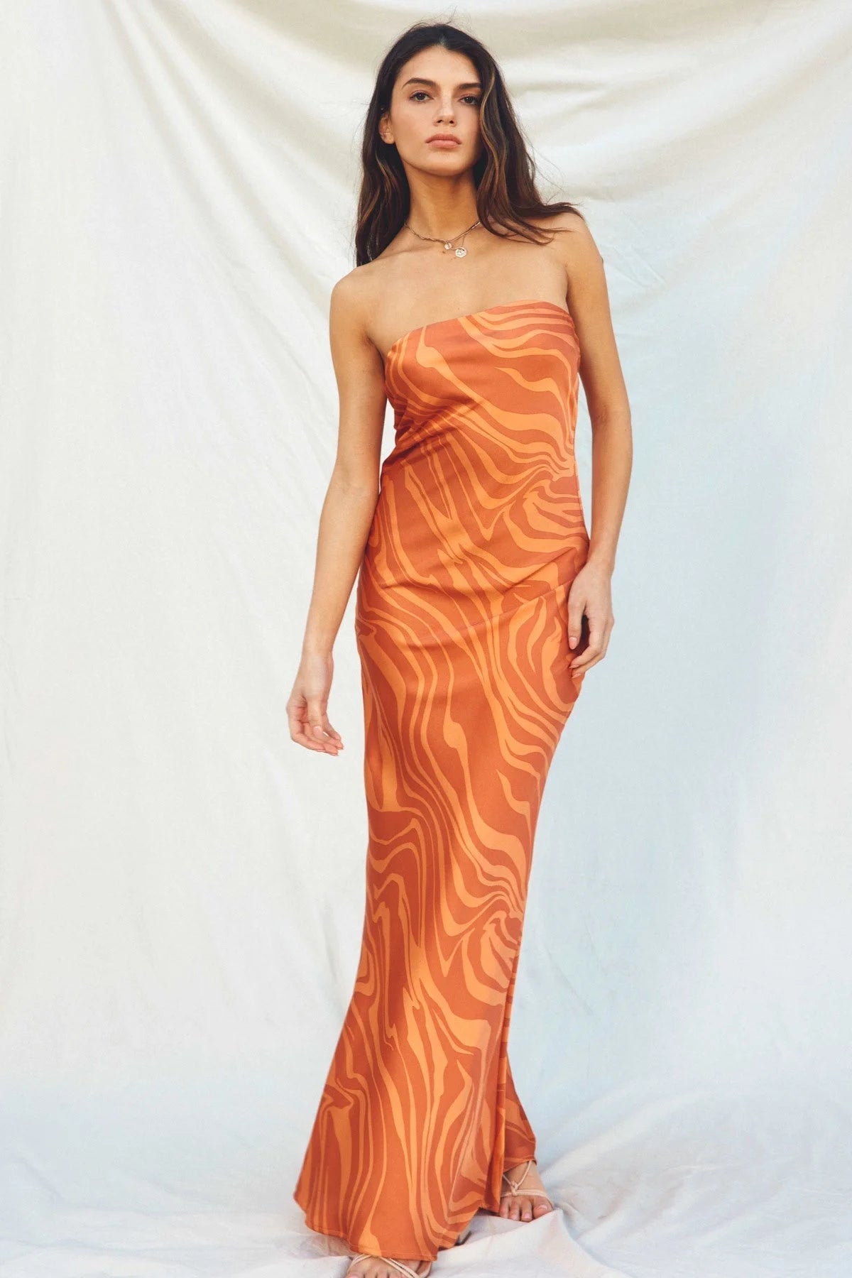 Strapless orange bias cut maxi dress featuring a textured pattern for a boho look