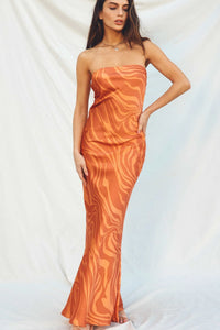 Strapless orange bias cut maxi dress with a swirling pattern for a boho look