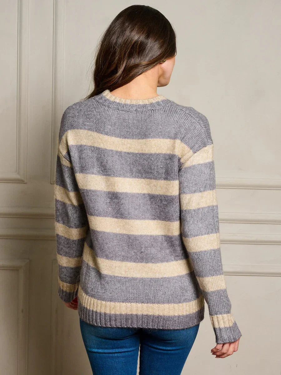 Striped gray and beige knit sweater on a model, perfect for women’s boho chic clothing