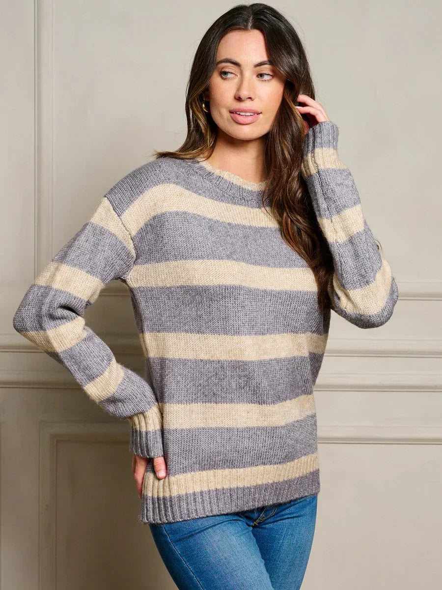 Striped gray and cream knit sweater on a woman showcasing women’s boho chic clothing